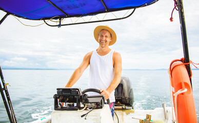 Man captain driving boat on ocean tour