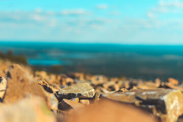 view from the mountain, stones in the foreground and perspective