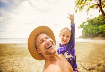nice man having great time on beach with his daughter
