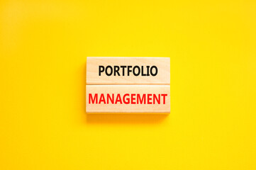 Portfolio management symbol. Concept words Portfolio management on beautiful wooden block. Beautiful yellow paper background. Business Portfolio management concept. Copy space.