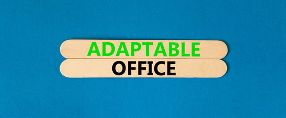 Adaptable office symbol. Concept words Adaptable office on beautiful wooden stick. Beautiful blue paper background. Business Adaptable office concept. Copy space.