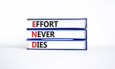 END effort never dies symbol. Concept words END effort never dies on beautiful books. Beautiful...