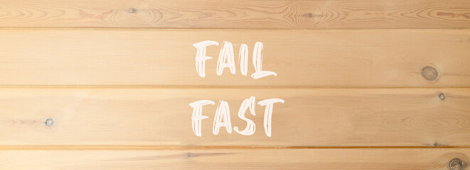 Fail fast symbol. Concept words Fail fast on beautiful wooden wall. Beautiful wooden wall...