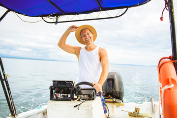 Man captain driving boat on ocean tour