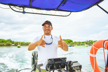 Man captain driving boat on ocean tour