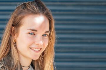 portrait blonde girl with blue eyes on the street outdoors