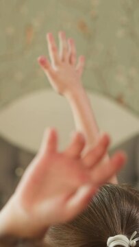 Boy and girl raise hands to answer question sitting at desk. Brother and sister study at home. Schoolchildren do homework with teacher in cozy room