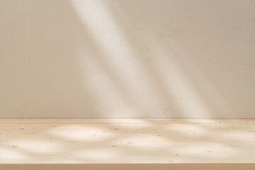 Wood empty table mockup on stucco background with abstract sun light reflections on the wall.