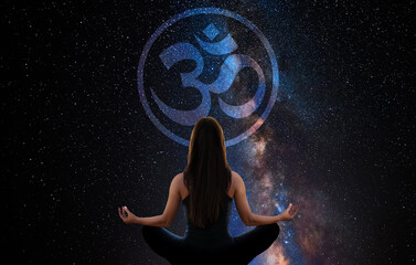 Woman meditating with the universe in the background with buddhist Om sign 