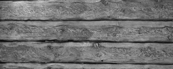Fragment of an old wall made of wooden beams