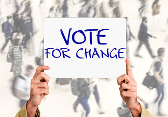 Hands holding a sign with the inscription: vote for change
