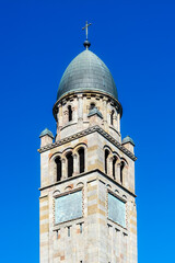 Fototapeta premium Tower of the Catholic Church of Saint Vincent de Paul with a dome and a cross against the blue sky in the city of Budapest.