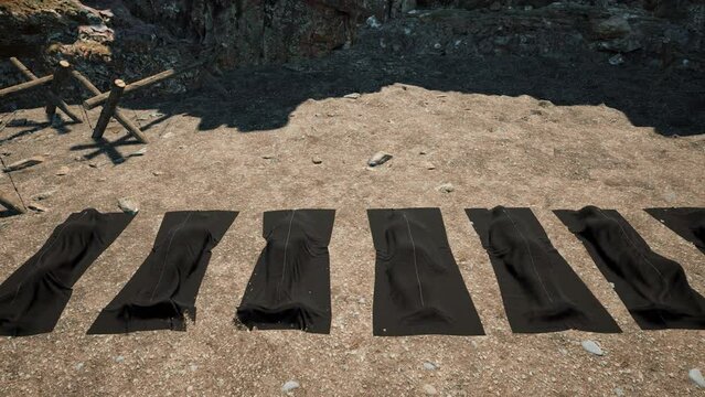 Casualties of war laid out on the ground in body bags in a war zone.