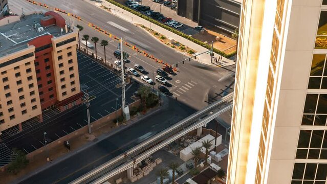 High angle timelapse of cars crossing a busy intersection in the center of Las Vegas city during sunset