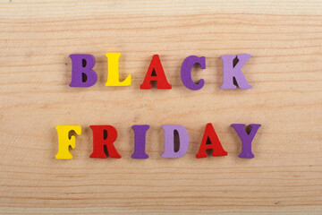 BLACK FRIDAY word on wooden background composed from colorful abc alphabet block wooden letters,...