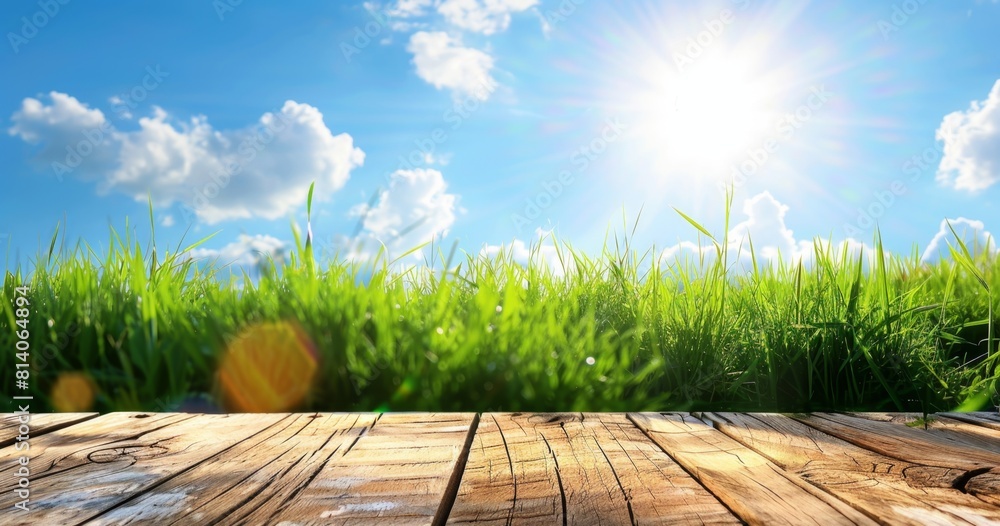 Poster beautiful spring background with green grass and a wooden table top, copy space for product presenta