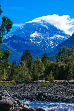 Lanin volcano surrounded by clouds, clear summit in sight and ice glaciers, between Argentina and Chile, Lanin National Park