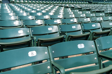 A row of green chairs with numbers on them