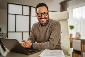 Obraz premium Portrait of one adult businessman sit and smile at office