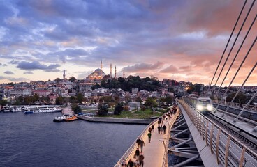 Istanbul metro station on the modern bridge on Golden Horn at sunset time.