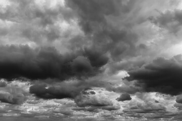 Storm sky with dark grey black clouds abstract background texture, thunderstorm. Black and white...