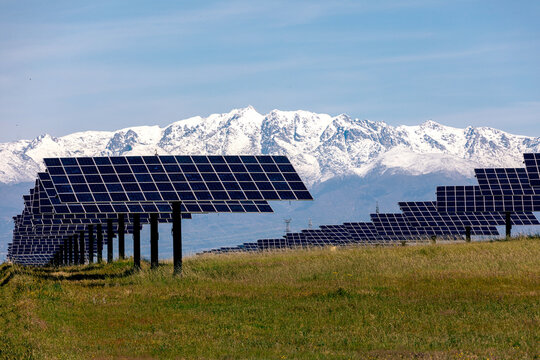 Solar Panels in Front of Snowy Mountain Range
