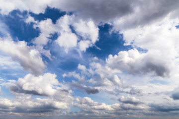 Epic dramatic Blue sky with many white fluffy cumulus clouds in sunlight, background texture, heaven