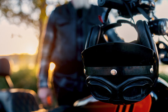 Motorcycle helmet and biker in the sunset