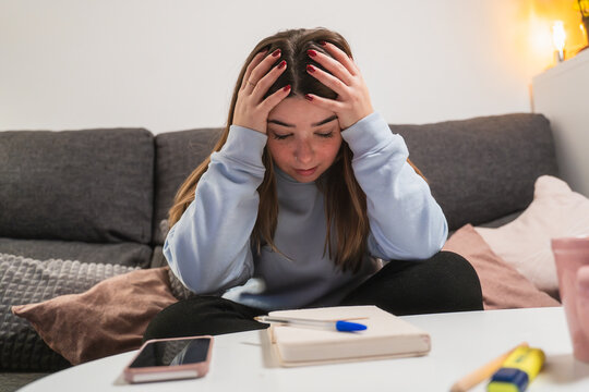 Young woman feeling stressed at home