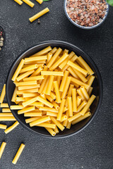 raw pasta cooking tortiglioni appetizer meal food snack on the table copy space food background rustic top view