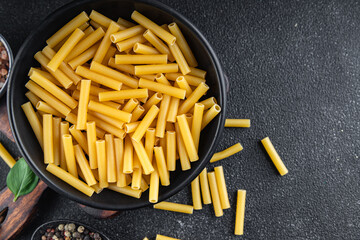 raw pasta cooking tortiglioni appetizer meal food snack on the table copy space food background rustic top view