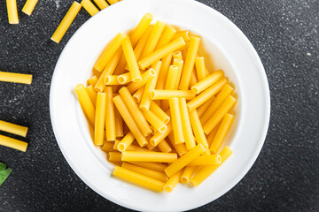 raw pasta cooking tortiglioni appetizer meal food snack on the table copy space food background rustic top view