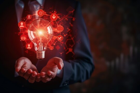 A businessman holds an illuminated light bulb with red warning signs and icons .