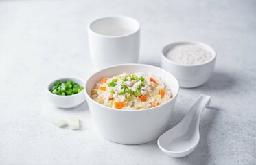 Asian rice chicken soup with carrots and celery in a bowl