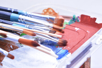 a set of dirty brushes and paintbrushes from having painted too much