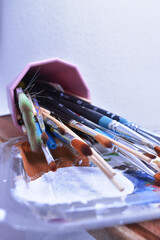 a set of dirty brushes and paintbrushes from having painted too much