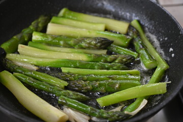 Green roasted asparagus, green branches of cooked asparagus, healthy food, vegetarianism 