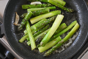 Green roasted asparagus, green branches of cooked asparagus, healthy food, vegetarianism 