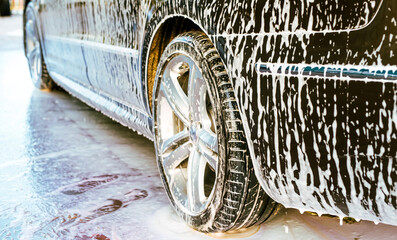 White foam is applied to the car body at the car wash