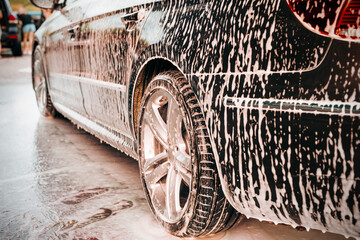 White foam is applied to the car body at the car wash