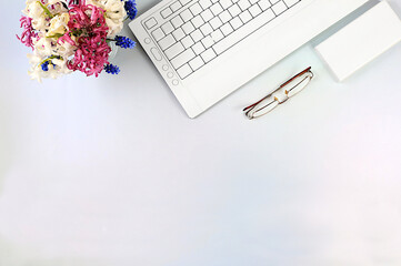 Modern feminine desk, home office. Computer, hyacinth flowers and smartphone on an elegant table,...