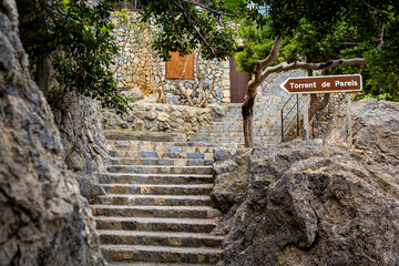 Staircase in Port De Sa Calobra, illustrating its role in guiding visitors to the Torrent de Pareis canyon, ideal for showcasing Mallorca natural wonders in travel guides and tourist destinations.