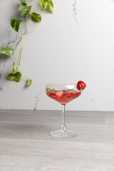 a cocktail with strawberries and basil