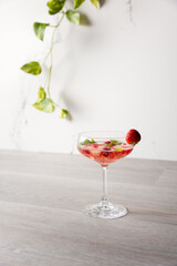 a cocktail with strawberries and basil