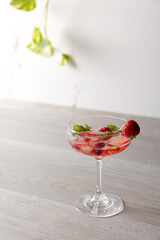 a cocktail with strawberries and basil