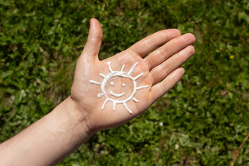 A person applying the correct amount of sunscreen for face and neck.
