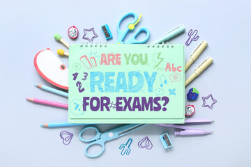 Notebook with different stationery supplies on blue background