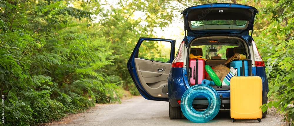 Wall mural modern car with luggage outdoors