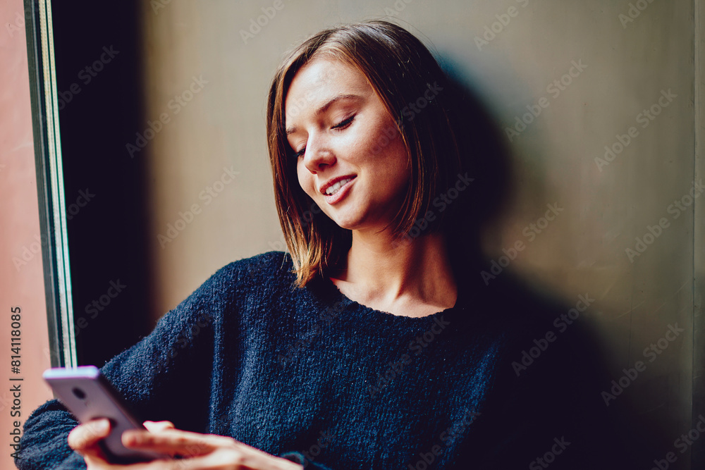 Poster cheerful young woman using free high speed internet connection for chatting online on smartphone dev