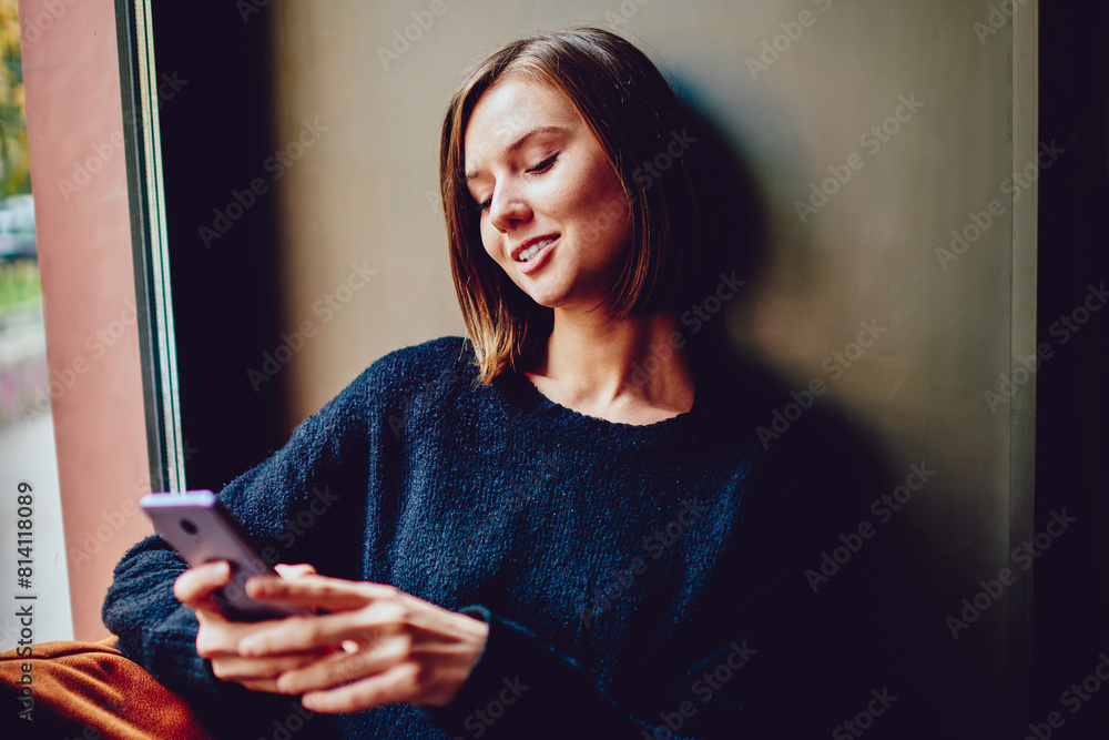 Poster cheerful young woman using free high speed internet connection for chatting online on smartphone dev
